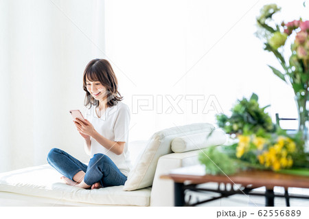 女性 スマホ リビング かわいい ライフスタイル カジュアル 女性 スマホ リビング かわいい ライフスタイル カジュアル 62556889