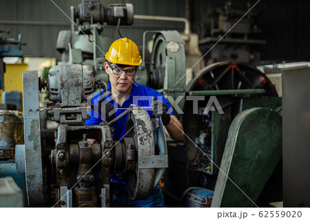 Man Industry wearing helmet safety working repair machine in factory. Man Industry wearing helmet safety working repair machine in factory. 62559020