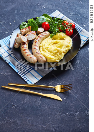 French potato aligot with sausage and fresh salad 62561583
