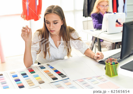 Fashion designer studio measuring textile material Fashion designer studio measuring textile material 62565654