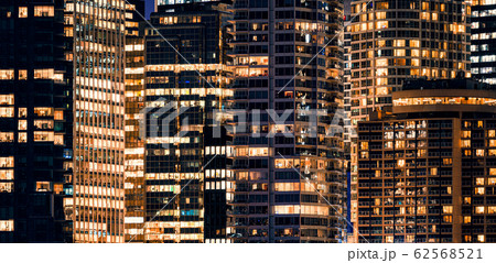 Facade windows of illuminated modern skyscraper 62568521