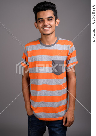 Young Indian man against gray background 62568536