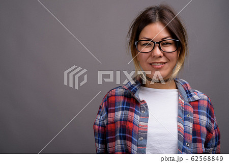 Young beautiful Kazakh woman against gray background Young beautiful Kazakh woman against gray background 62568849