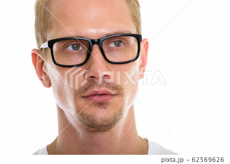 Close up of young handsome man thinking and looking at distance 62569626
