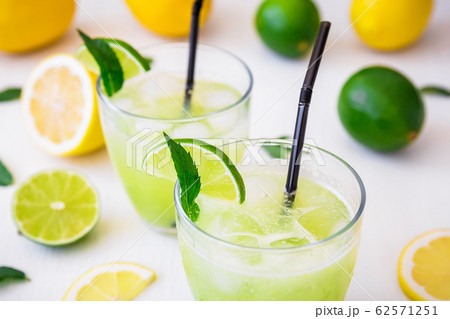 Citrus cold lemonade with limes, mint and lemons in glasses 62571251