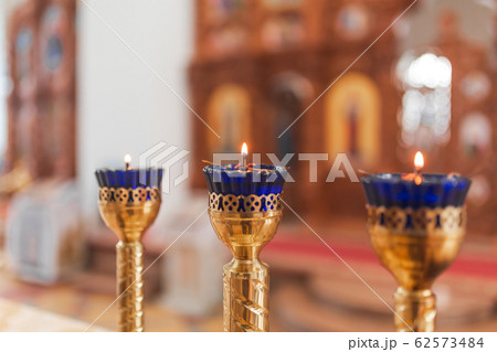 Orthodox Church Lamps with lit candles in blue 62573484