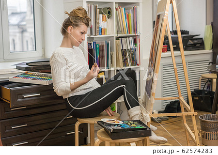 Portrait of a woman artist crayon painting in the 62574283