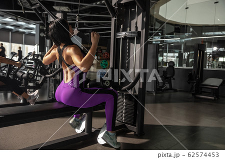 The female athlete training hard in the gym. Fitness and healthy life concept. 62574453
