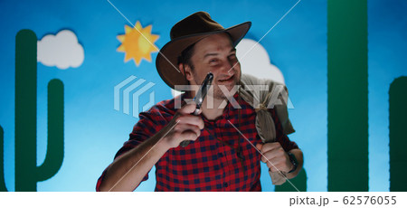 Happy robber looking at camera with sack and handgun Happy robber looking at camera with sack and handgun 62576055