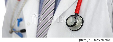 Stethoscope lying on male therapeutist doctor chest Stethoscope lying on male therapeutist doctor chest 62576708