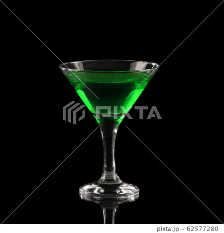 Green alcoholic cocktail in a glass on black Green alcoholic cocktail in a glass on black 62577280