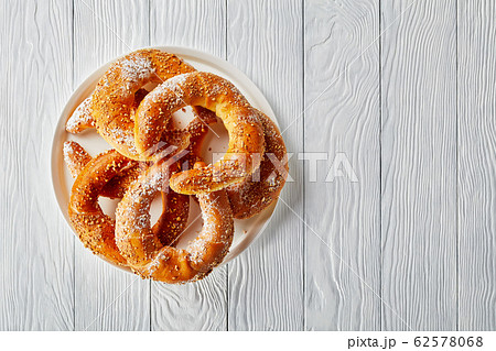 Sweet pastry rolls on a white wooden background 62578068