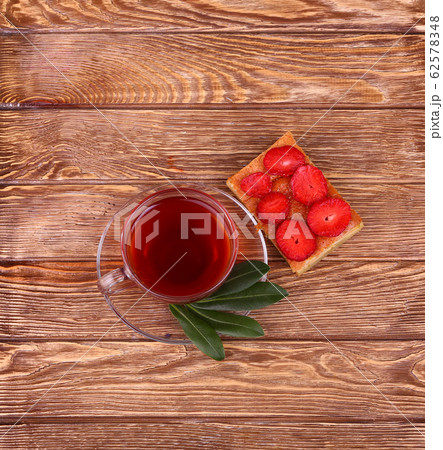 sweet cake with cup of tea on wooden table sweet cake with cup of tea on wooden table 62578348