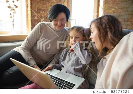 Happy loving family. Grandmother, mother and daughter spending time together Happy loving family. Grandmother, mother and daughter spending time together 62578525