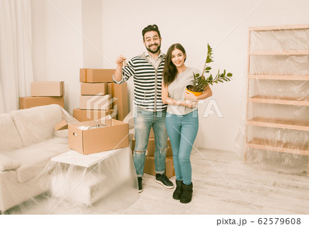 Caucasian young couple happy to moving in to new apartment. Caucasian young couple happy to moving in to new apartment. 62579608