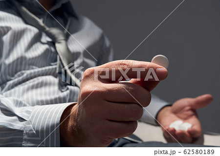 businessman with poor health, hands close view - 62580189