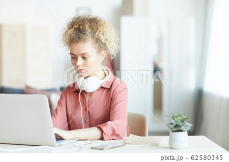 Woman working at her workplace Woman working at her workplace 62580345