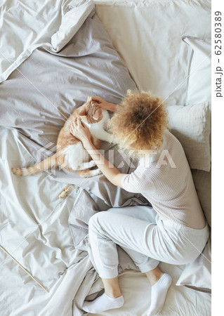 Girl with pet in the bed Girl with pet in the bed 62580389