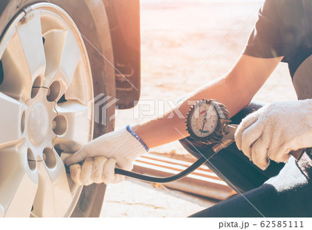 Asian man car inspection Measure quantity Inflated 62585111