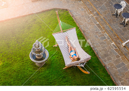 Slender beautiful young woman in a swimsuit is Slender beautiful young woman in a swimsuit is 62595554