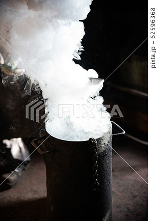 Blacksmith forging - Cooling out detail in the bucket of cool water 62596368