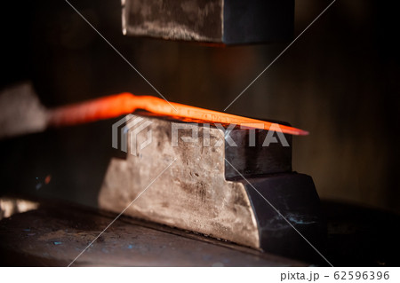 Blacksmith machine for forging a deta il out of the hot metal Blacksmith machine for forging a deta il out of the hot metal 62596396