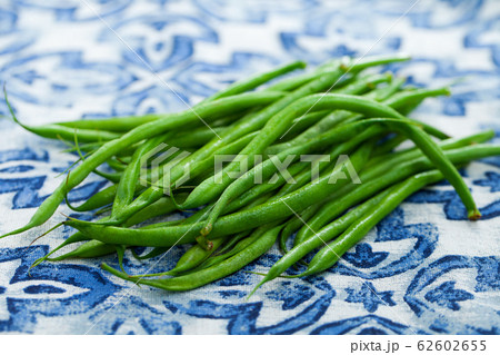 Green beans on blue and white background. Close up. 62602655