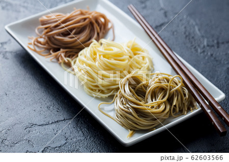 Soba noodles variety on a white plate. Japanese food. Black slate background. Close up. Soba noodles variety on a white plate. Japanese food. Black slate background. Close up. 62603566