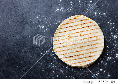 Grilled tortillas, flat breads on dark grey background. Copy space. Top view. 62604164