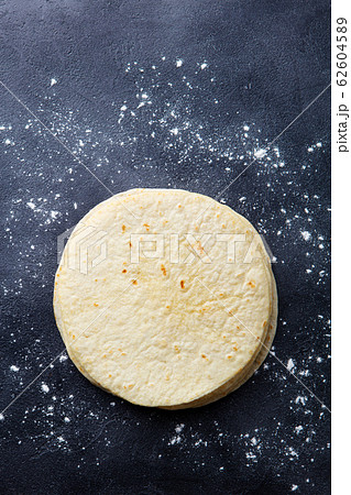 Tortillas, flat breads on dark grey background. Copy space. Top view. Tortillas, flat breads on dark grey background. Copy space. Top view. 62604589