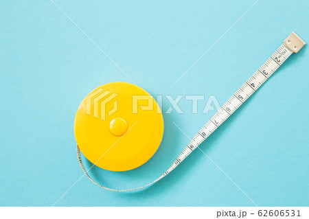 Tape measure on blue color background Tape measure on blue color background 62606531