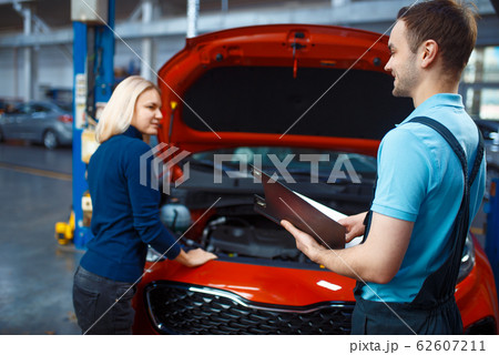 Driver and worker with checklist, car service 62607211