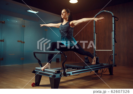 Slim girl keeps the balance, pilates training 62607326
