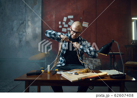 Maniac kidnapper prepares rope for his victim Maniac kidnapper prepares rope for his victim 62607408