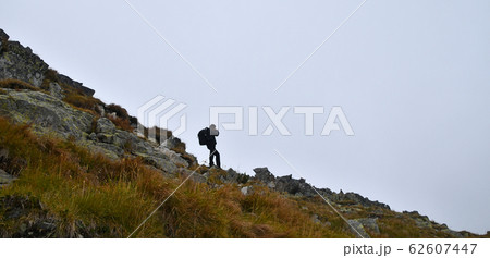 Side view of man photographer in foggy mountains 62607447