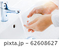 Woman use soap and washing hands under the water tap. Hygiene concept hand detail 62608627