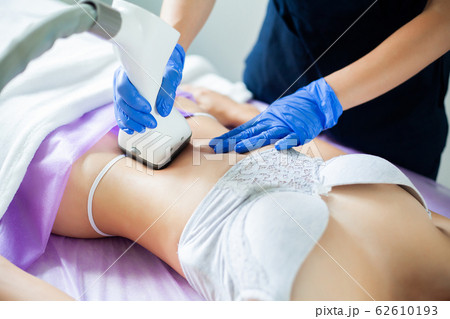 Skin care. Woman is in the process at the clinic lipomassage. 62610193