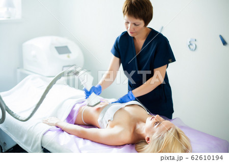 Skin care. Woman is in the process at the clinic lipomassage. 62610194