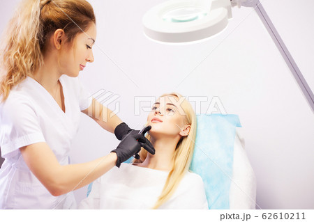 Lip Augmentation In Cosmetology Clinic. Beautiful Woman Getting Beauty Injection For Lips. Lip Augmentation In Cosmetology Clinic. Beautiful Woman Getting Beauty Injection For Lips. 62610211