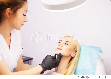 Lip Augmentation In Cosmetology Clinic. Beautiful Woman Getting Beauty Injection For Lips. 62610212
