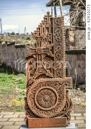 Stone cross carved with ornaments in the form of the tenth letter of the Armenian alphabet, created by Mesrop Mashtots in the village of Oshakan Stone cross carved with ornaments in the form of the tenth letter of the Armenian alphabet, created by Mesrop Mashtots in the village of Oshakan 62610273