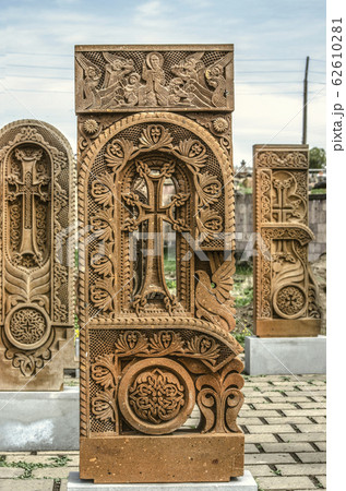 Stone cross carved with ornaments in the form of the second letter  of the Armenian alphabet, created by Mesrop Mashtots in the village of Oshakan 62610281