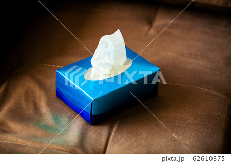 Box hygiene napkins on the brown sofa. 62610375