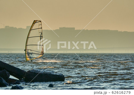 A male athlete is interested in windsurfing.  62616279
