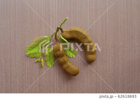 Green leaf and Tamarind on a wooden floor. , Green leaf and Tamarind on a wooden floor. , 62618693