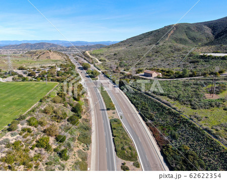 Curving road and downhill with houses in suburb of San Diego 62622354
