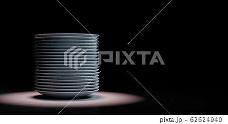 Heap of White Porcelain Dishes Spotlighted on Black Background 62624940