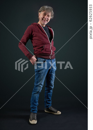 Portrait of a man with red shirt and denim pant on Portrait of a man with red shirt and denim pant on 62625933