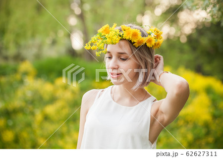 Portrait of young spring woman in flowers garden Portrait of young spring woman in flowers garden 62627311