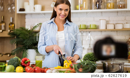 Healthy nutrition blog. Girl cooking vegetable salad Healthy nutrition blog. Girl cooking vegetable salad 62627619